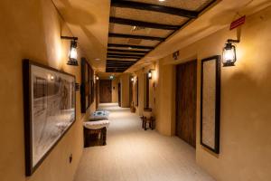a hallway of a hospital with lights and a hallway with a hallway at The Luxe Retreat Hotel Apartments in Dubai