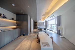 a living room with a long table and chairs at The Moor Wellnsee Pool Villa in Busan
