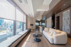 a living room with a couch and a large window at The Moor Wellnsee Pool Villa in Busan