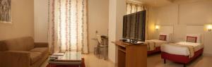 Letto o letti in una camera di Avalon Courtyard Residence Suites