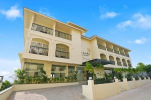 a large yellow building with a lot of windows at Amaari Beach Resort in Kanyakumari