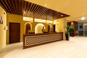 a lobby with people sitting at a reception desk at The Luxe Retreat Hotel Apartments in Dubai +112 photos