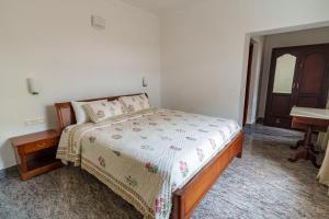 a bedroom with a bed and a desk and a piano at Orma in Cochin