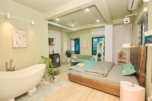 a bedroom with a tub and a bed and a bath tub at Trên Mây HST - 91 Cầu Diễn in Văn Trì