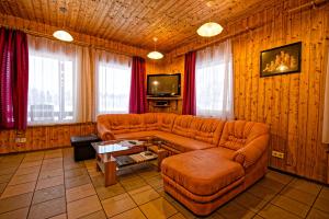 a living room with a couch and a tv at Atpūtas vieta Upes Sausītes in Sidrabiņi