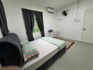 a small bedroom with a bed and a window at DNH Nilam Puri Homestay Unit B in Kota Bharu +5 photos