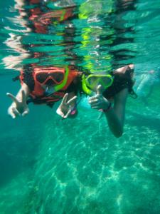 a person swimming in the water with a snorkel at Private Balinese Bungalow for 2 - Shared pool - Lamai Koh Samui in Nathon Bay