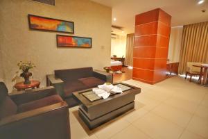 a living room with a couch and a table at The Altruist Hitech Hotel in Hyderabad +67 photos