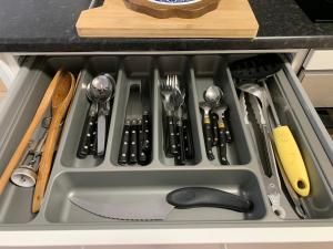 a kitchen sink with utensils in a drawer at Cosy New Studio 2 min RER B in Aulnay-sous-Bois +13 photos