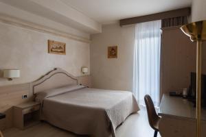 a hotel room with a bed and a window at Hotel Gialletti in Orvieto +37 photos