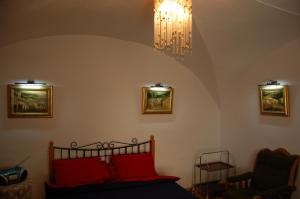 a bedroom with a bed and a chandelier at Mieszkanie Old Town Apartment in Vilnius