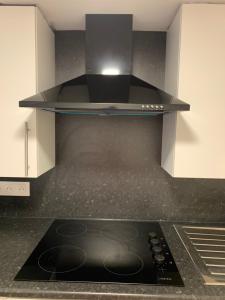 a kitchen with a stove top oven in a kitchen at Cosy New Studio 2 min RER B in Aulnay-sous-Bois