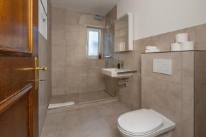 a bathroom with a toilet and a sink at Cocoa Suite · Kilchberg in Kilchberg