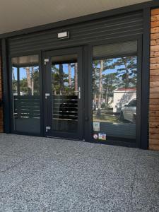 two entrances to a building with three glass doors at Forest House Razanac in Ražanac +3 photos