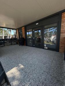 an empty room with glass doors on a house at Forest House Razanac in Ražanac