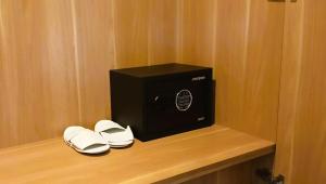 a black box and a pair of shoes on a shelf at Widji Garden Villa in Uluwatu