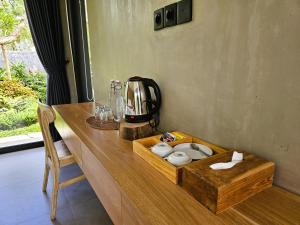 a wooden table with a tray with toiletries on it at Widji Garden Villa in Uluwatu