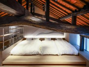 a bedroom with a large bed in a wooden ceiling at The 曜 Terrace in Hirado