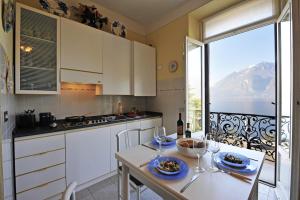a kitchen with a table and a view of a mountain at Bella Varenna in Varenna