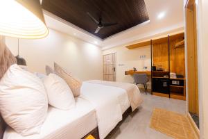 a hotel room with a bed and a desk at Fen Villa in Dharavandhoo