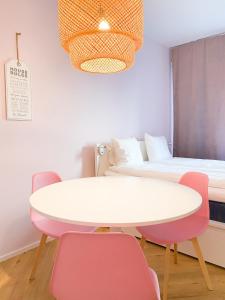 a room with a table and chairs and a bed at Studio Flamingo in Helsinki