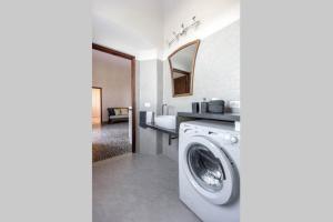 a washing machine in a bathroom with a sink at Terrazza a Campana in Panzano