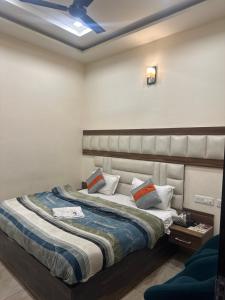 a bedroom with two beds and a ceiling at Hotel Crown Inn in Jalandhar
