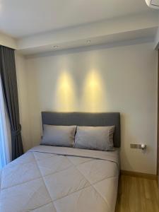 a bed in a bedroom with lights on the wall at Laguna SkyPark in Laguna Phuket +10 photos