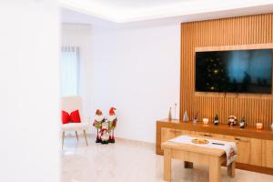 a living room with a flat screen tv on a wall at Casa Anda in Pucioasa