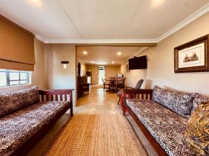 a living room with couches and a table at The Grove in Potchefstroom