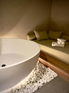 a bath tub sitting in a room with a couch at Hedonist SPA in Jagodina +25 photos