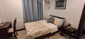 a small bedroom with a bed and a desk at 1898 Casa and Restaurante in Silay