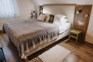 a bedroom with a large bed and a table at Relax Balaton Apartmanok in Balatonfüred +57 photos