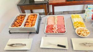 a table topped with trays of different types of food at Pensiunea Panoramic in Stațiunea Climaterică Sâmbăta +20 photos