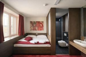 a small bedroom with a bed and a bathroom at Kongres Hotel Roca in Košice +97 photos