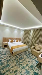 a bedroom with a large bed and a couch at نوف بلازا nouf plaza for serviced apartments in Ad Dawādimī +52 photos