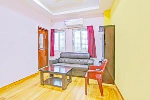 a living room with a couch and a table at Hotel O Nandhi Inn in Vemalwāda