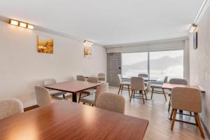 a room with tables and chairs and a large window at Comfort Inn & Suites Ormond Beach Oceanfront in Ormond Beach