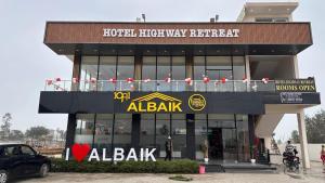 a building with aaa bank sign on top of it at Hotel Highway Retreat in Gajraula