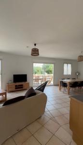 a living room with a couch and a table at Manureva Calvi in Calvi