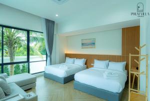 a hotel room with two beds and a couch at PHUM Villa Songkhla in Ban Saphan Yao +48 photos