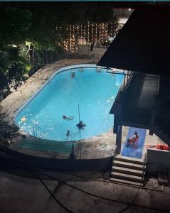 an overhead view of a large swimming pool with people in it at Hotel Express Airoli in Navi Mumbai