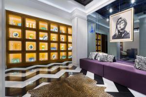 a room with a purple couch and a glass wall at Mirax Sapphire Boutique Hotel in Kharkiv