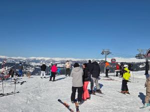 a group of people standing at the top of a ski slope at Guest House Nukri in Danisparauli