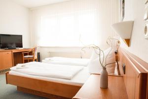 Postel nebo postele na pokoji v ubytování Hotel Am Meilenstein