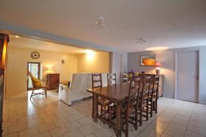 a dining room and living room with a table and chairs at Familial 'le chiron' in Thiat