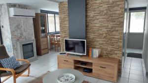 a living room with a tv on a wooden dresser at Opeteukske in Lanaken