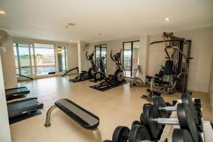 a gym with several treadmills and exercise bikes at Ratana Hotel Chalong in Rawai Beach