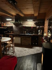a kitchen with wooden floors and a table with chairs at Brīdis Sev in Ķekava