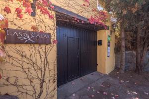 a black door on the side of a building at GuestReady - Hotel Rural Las Calas in Vega de San Mateo
